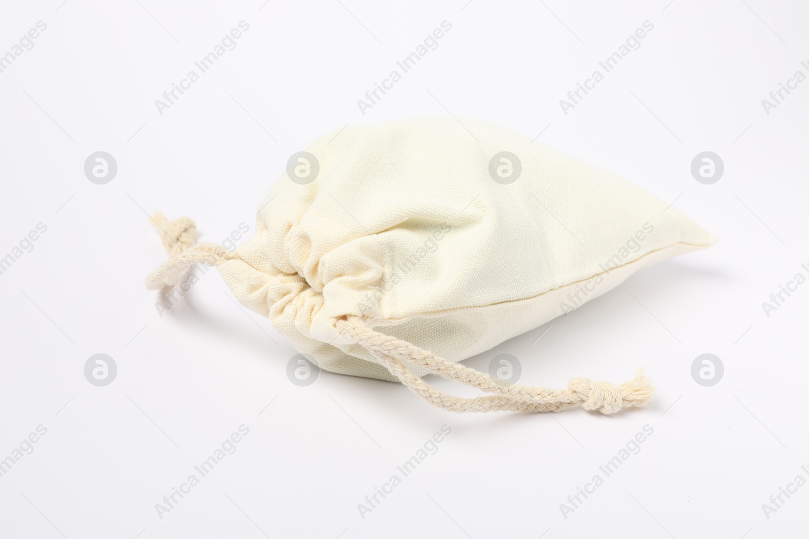 Photo of One cotton bag with ties on white background