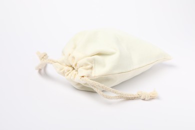 Photo of One cotton bag with ties on white background