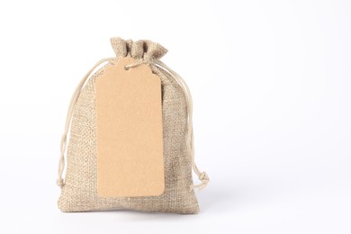 Photo of One burlap bag with tag on white background