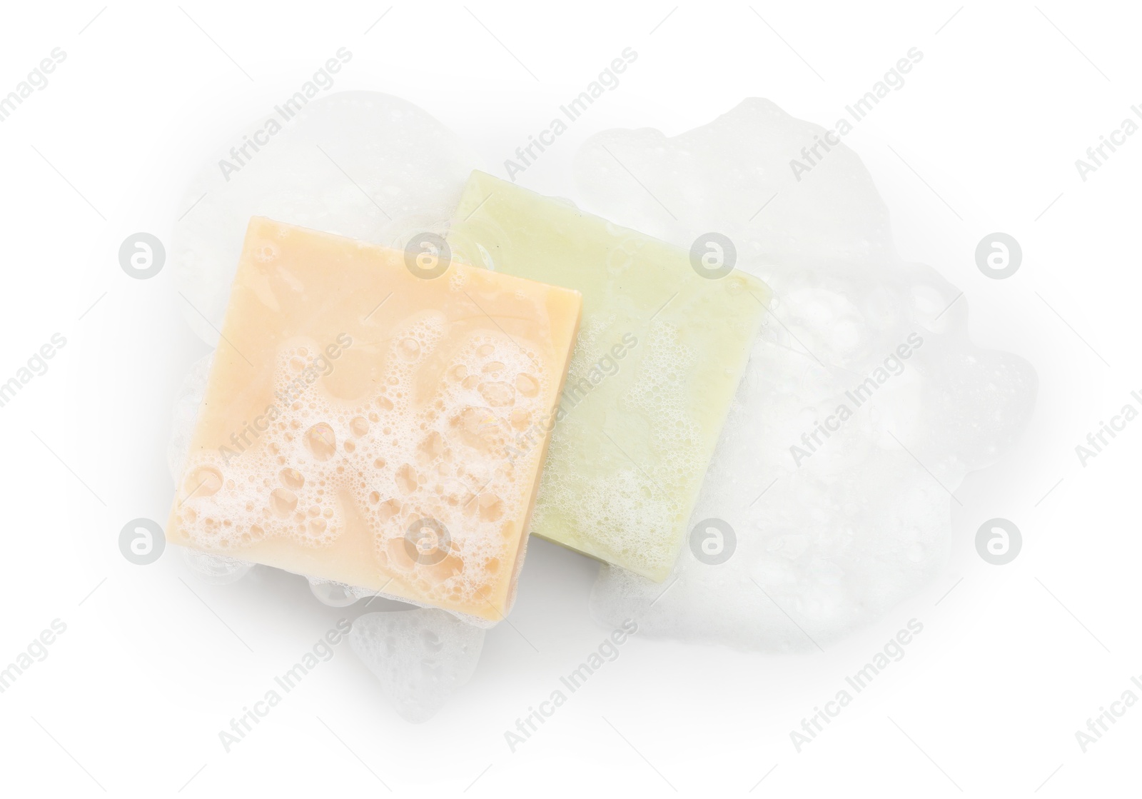 Photo of Soap bars with foam on white background, top view