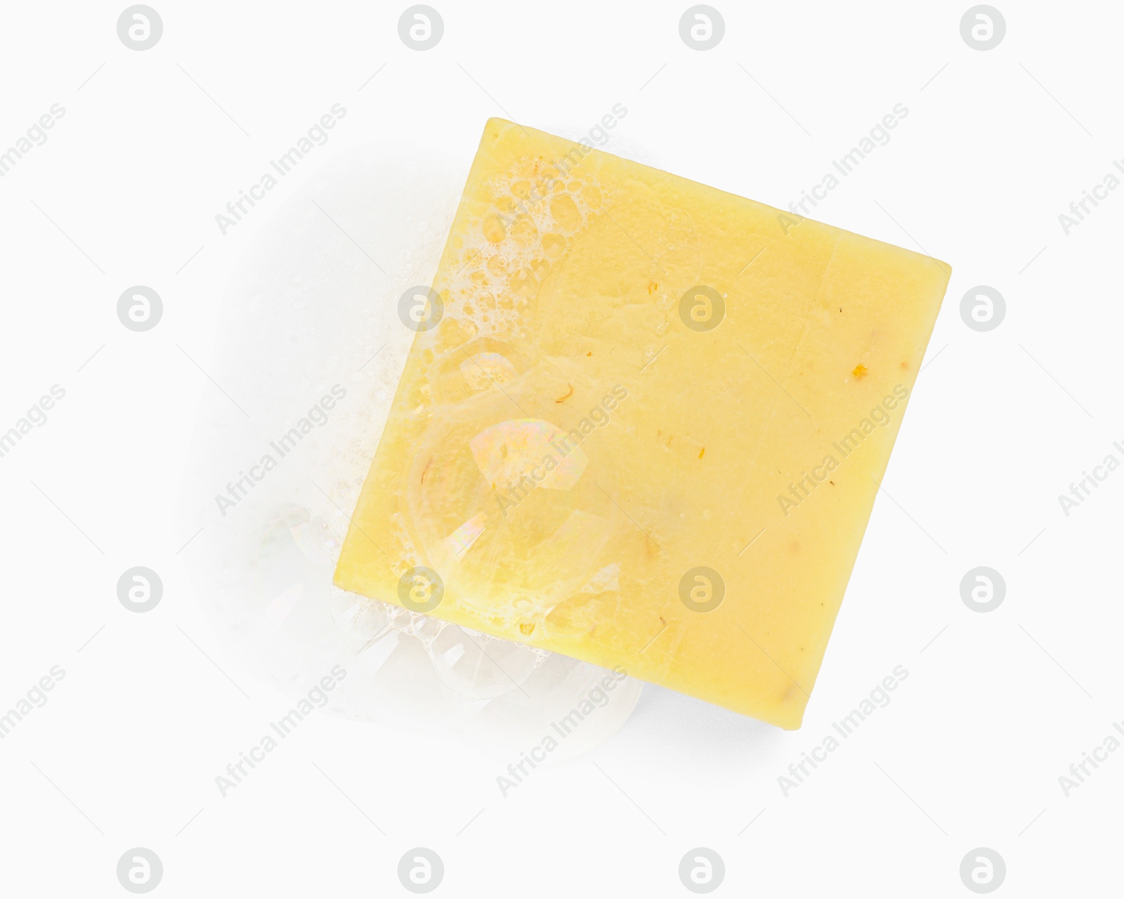 Photo of Yellow soap with foam on white background, top view