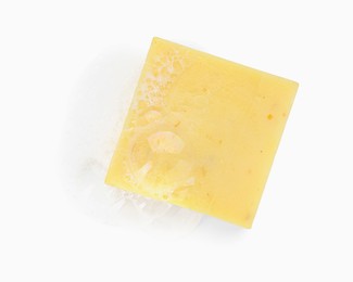 Photo of Yellow soap with foam on white background, top view