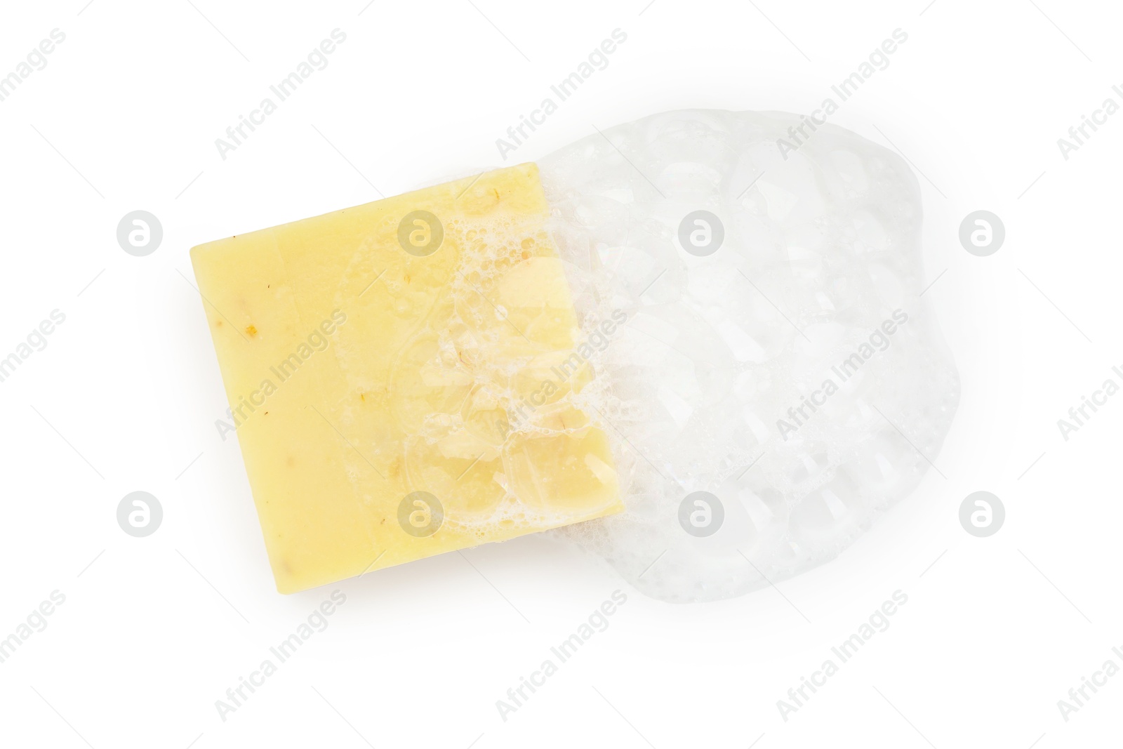 Photo of Yellow soap with foam on white background, top view