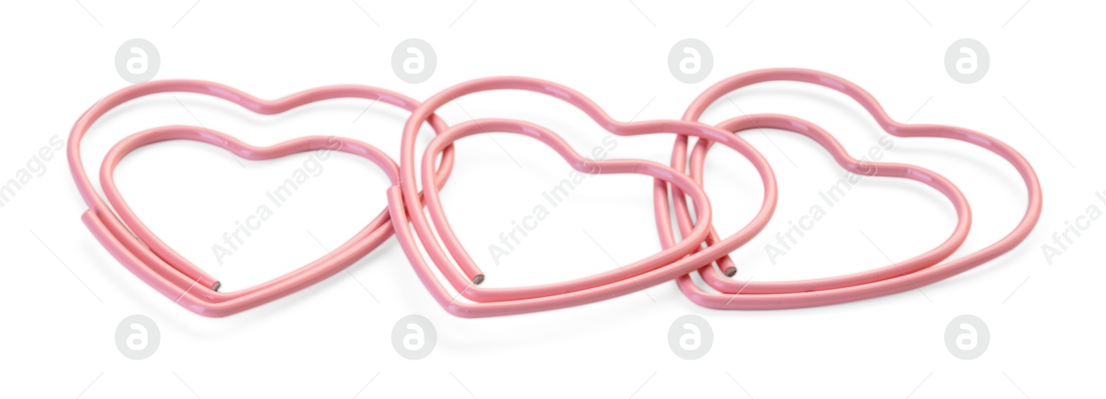 Photo of Heart shaped paper clips isolated on white