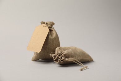 Photo of Two burlap bags on light grey background