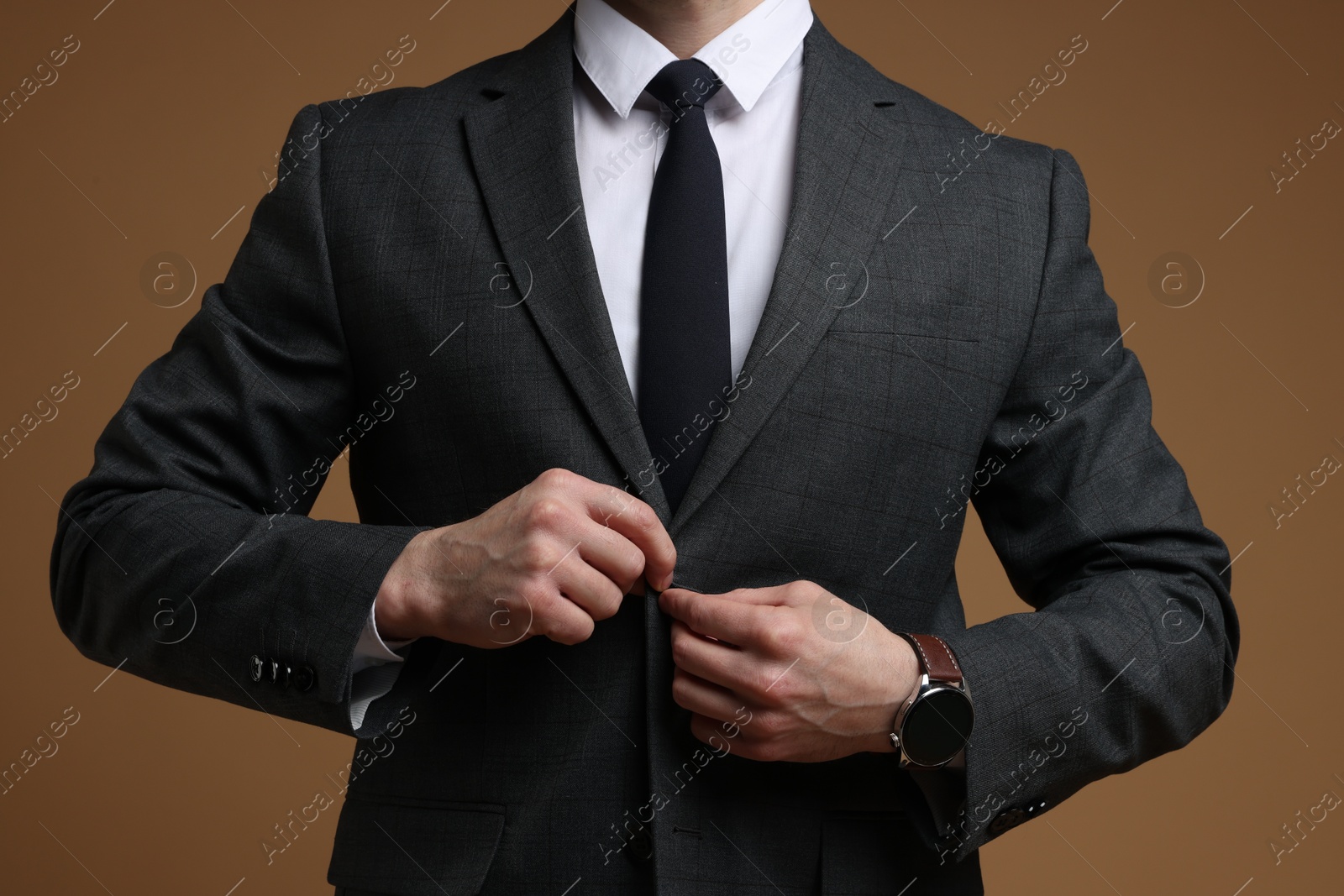 Photo of Man in classic suit on brown background, closeup