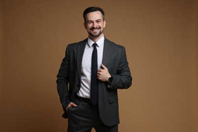 Photo of Handsome man in classic suit on brown background