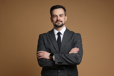 Photo of Handsome man in classic suit on brown background