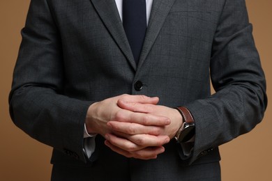 Photo of Man in classic suit on brown background, closeup