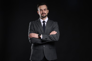 Photo of Confident man in classic suit on black background