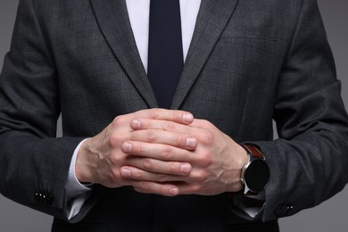 Photo of Man in classic suit on grey background, closeup