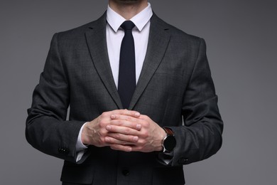 Photo of Man in classic suit on grey background, closeup