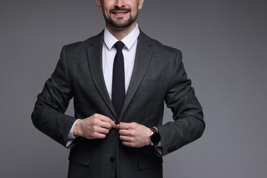 Photo of Man in classic suit on grey background, closeup