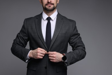 Photo of Man in classic suit on grey background, closeup