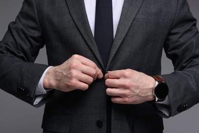 Photo of Man in classic suit on grey background, closeup