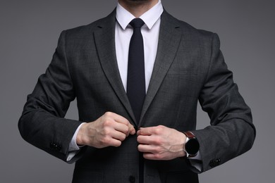 Photo of Man in classic suit on grey background, closeup