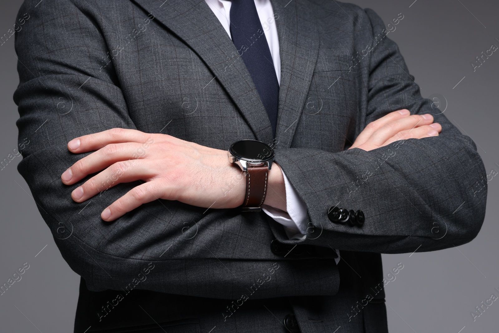 Photo of Man in classic suit on grey background, closeup