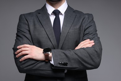 Photo of Man in classic suit on grey background, closeup