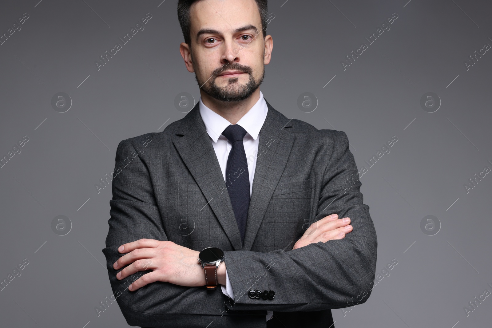 Photo of Confident man in classic suit on grey background