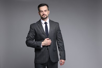 Photo of Confident man in classic suit on grey background