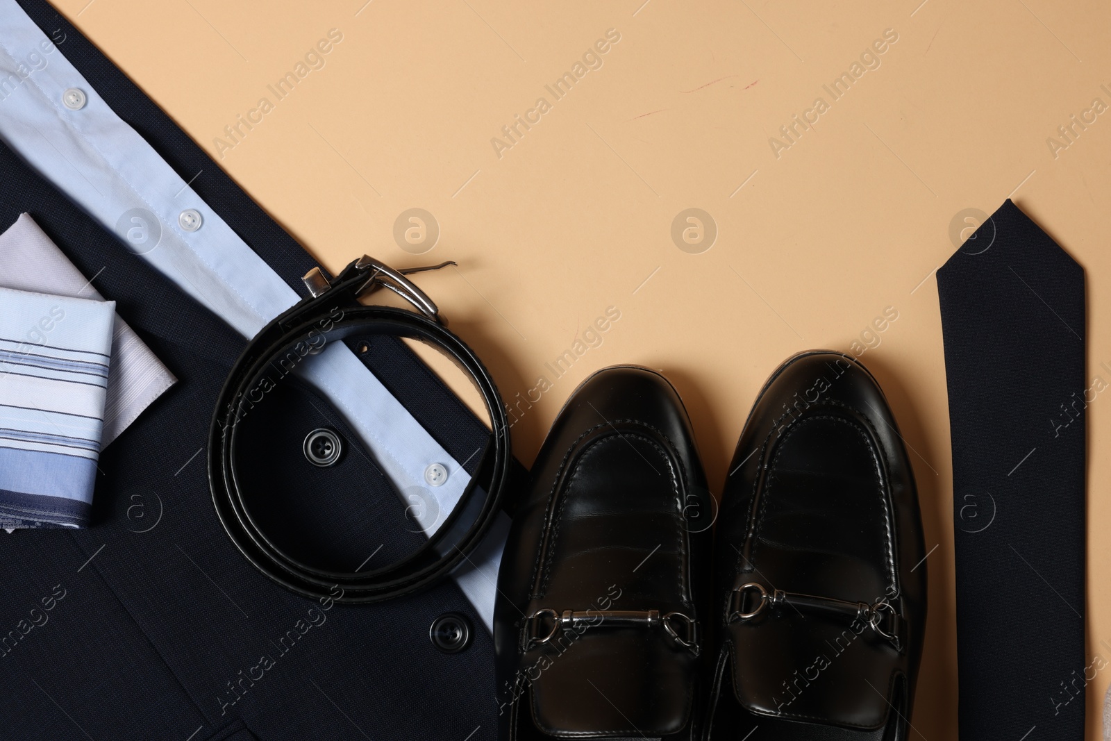 Photo of Elegant men's outfit. Stylish clothes, accessories and shoes on beige background, flat lay. Space for text