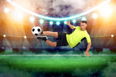 Image of Young man playing football under lights at stadium