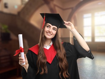 Image of Happy student in academic dress holding diploma after graduation in university