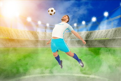 Image of Young man playing football under lights at stadium