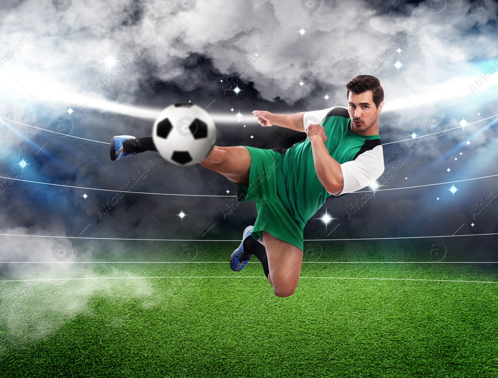 Image of Young man playing football under lights at stadium