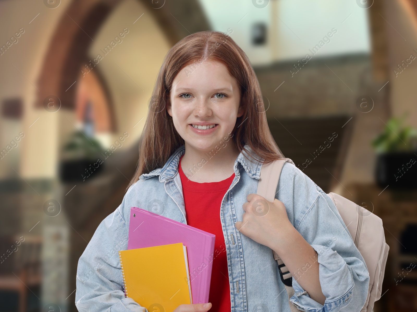 Image of Teenage student with notebooks and backpack in college