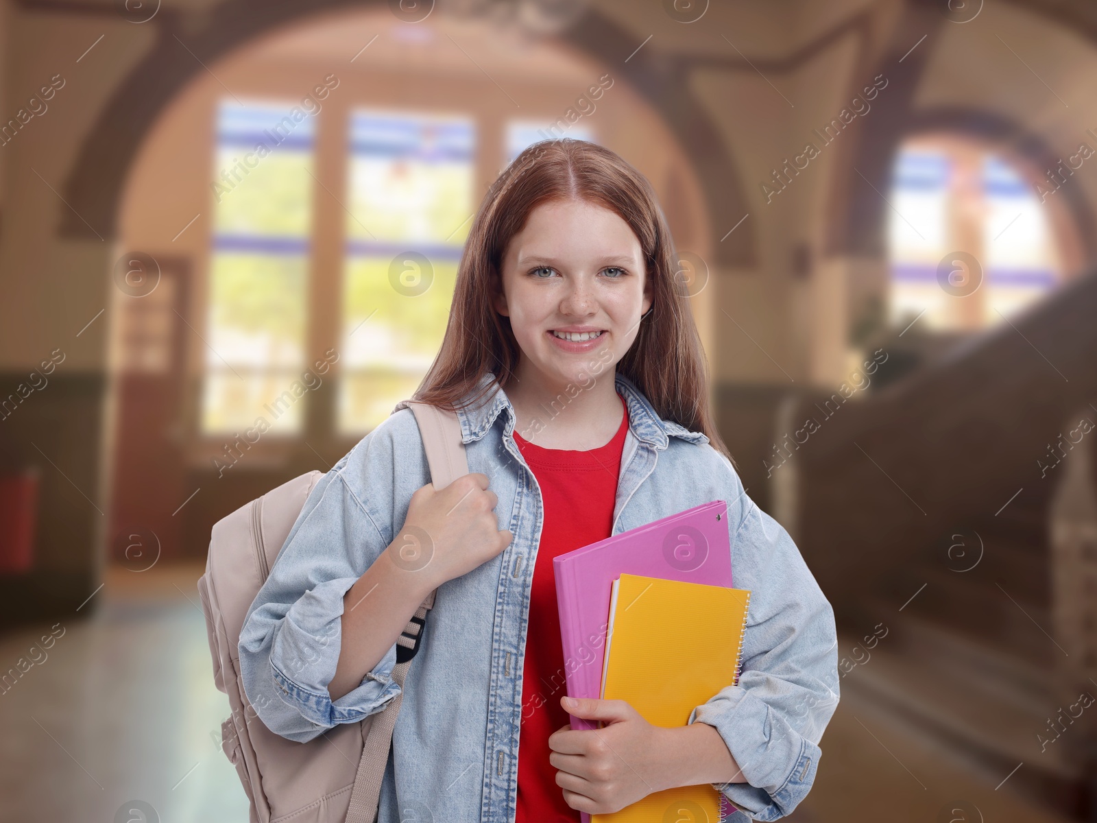 Image of Teenage student with notebooks and backpack in college