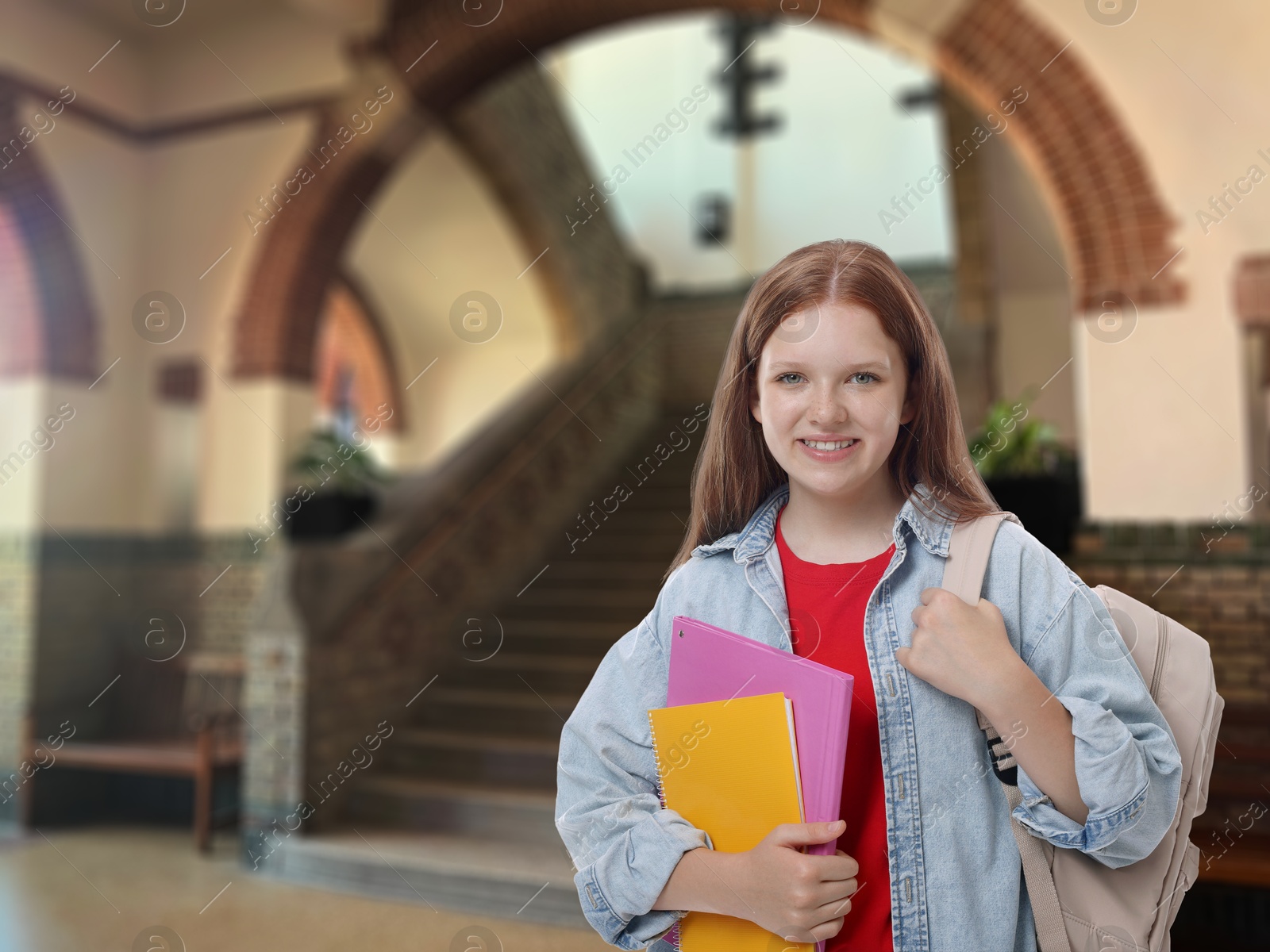 Image of Teenage student with notebooks and backpack in college