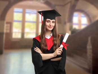 Image of Happy student in academic dress holding diploma after graduation in university