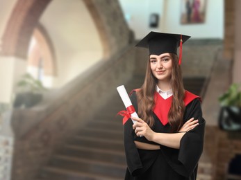 Image of Happy student in academic dress holding diploma after graduation in university