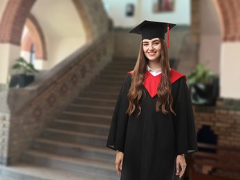 Image of Happy student wearing academic dress during graduation in university