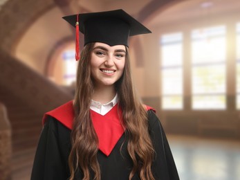 Image of Happy student wearing academic dress during graduation in university