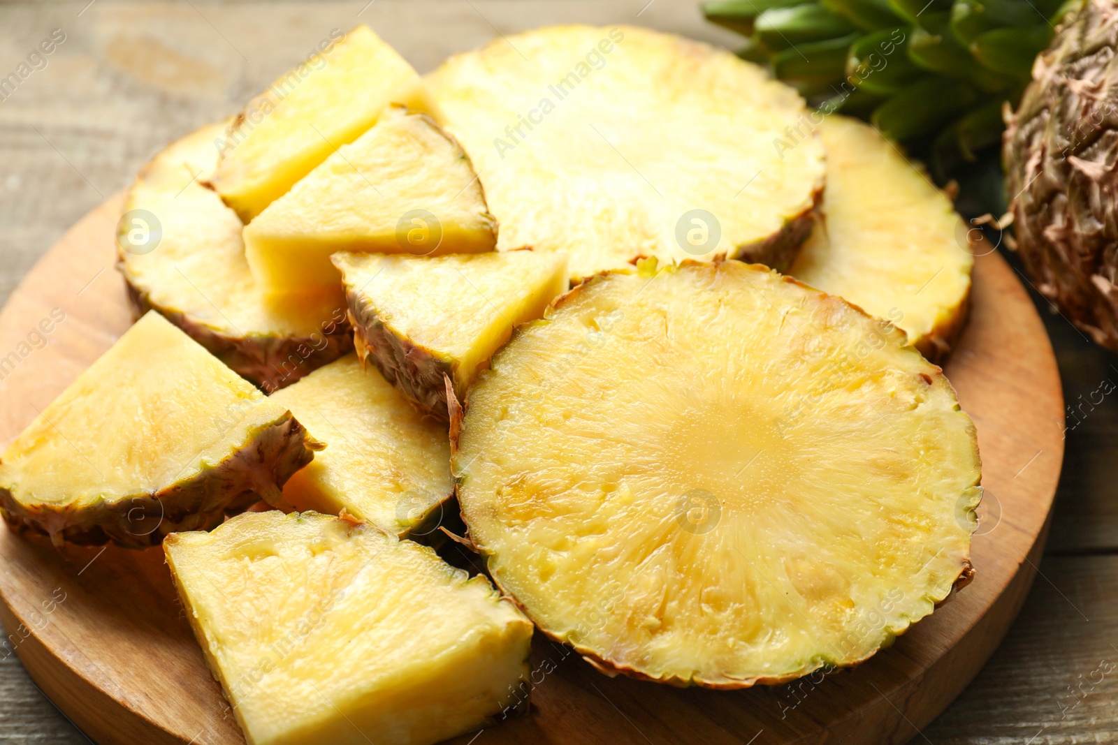 Photo of Slices of fresh ripe pineapple on table, closeup