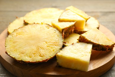 Photo of Slices of fresh ripe pineapple on table, closeup