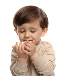 Photo of Cute little child eating tasty mochi on white background