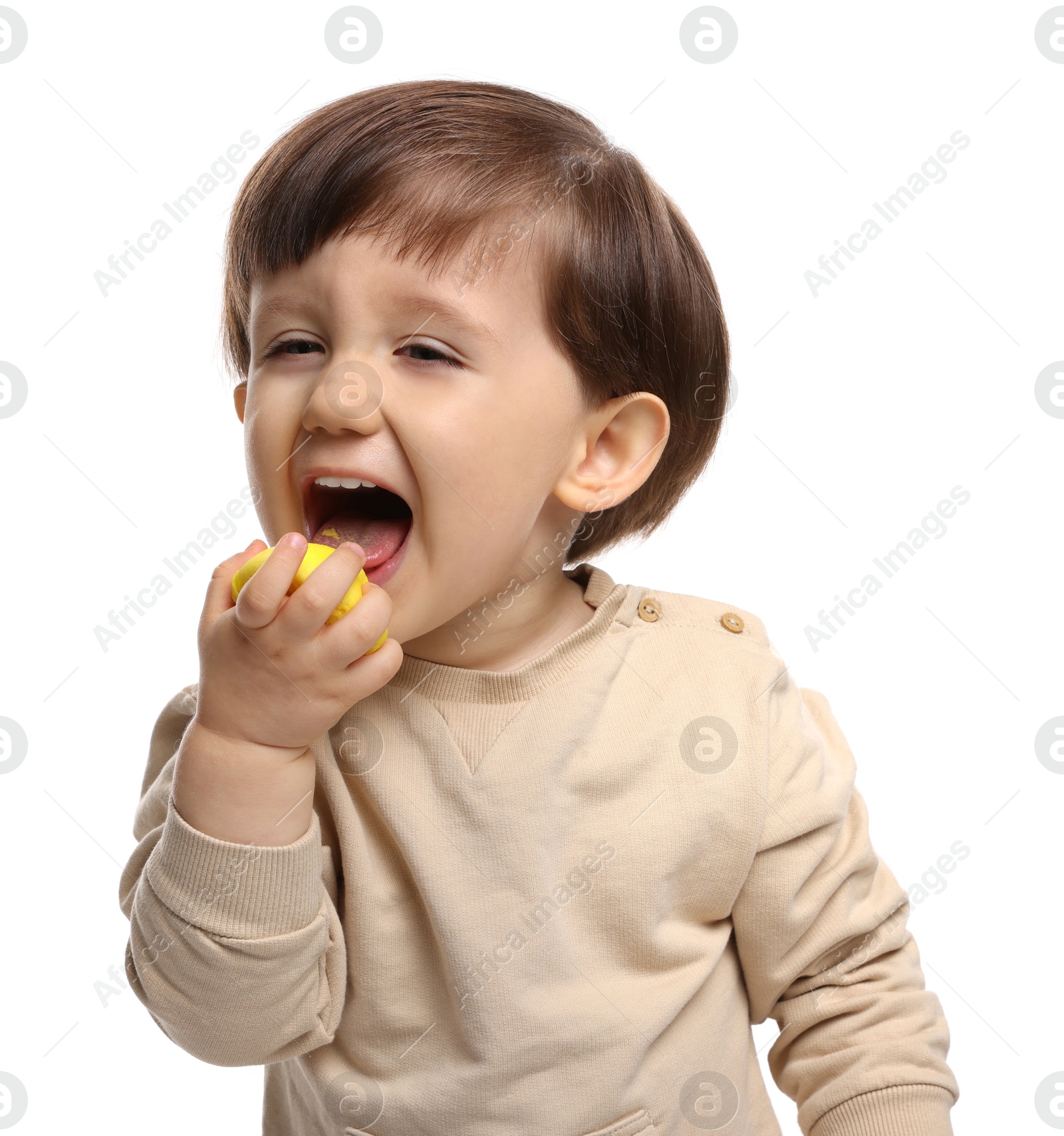 Photo of Cute little child eating tasty mochi on white background