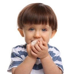 Cute little child eating tasty mochi on white background