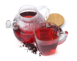 Photo of Tasty hibiscus tea in glass cup and teapot isolated on white