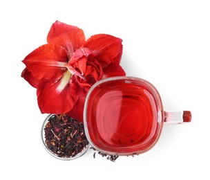 Photo of Tasty hibiscus tea in glass cup and flower isolated on white, top view