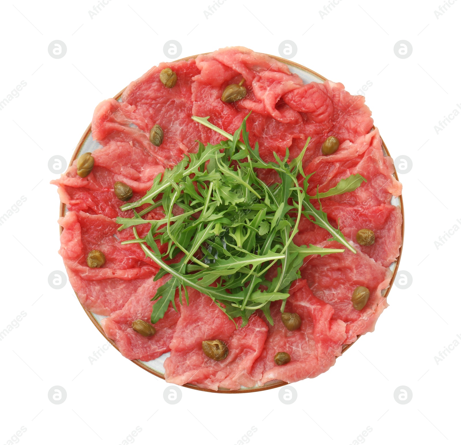 Photo of Delicious beef carpaccio with arugula and capers isolated on white, top view