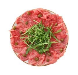 Photo of Delicious beef carpaccio with arugula and capers isolated on white, top view