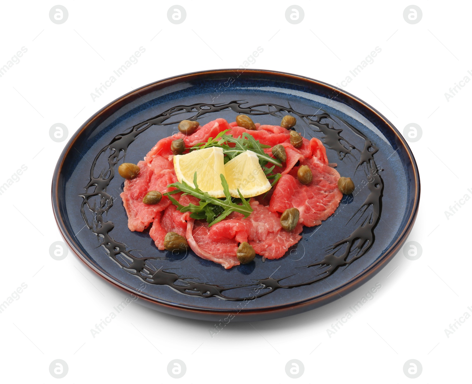 Photo of Fresh beef carpaccio with arugula, lemon and capers isolated on white