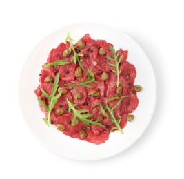 Photo of Fresh beef carpaccio with arugula and capers isolated on white, top view