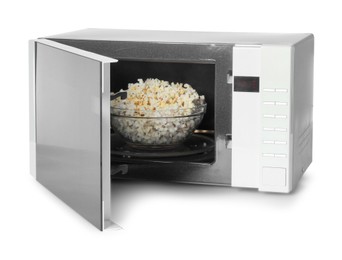 Photo of Open microwave oven with bowl of popcorn isolated on white