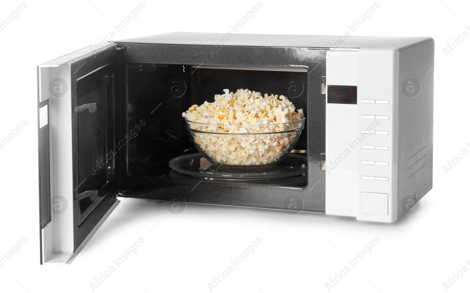 Photo of Open microwave oven with bowl of popcorn isolated on white