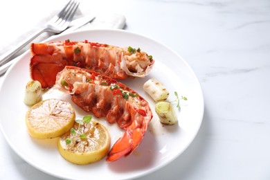 Photo of Delicious lobster tails with lemon, microgreens and green onion on white marble table, closeup